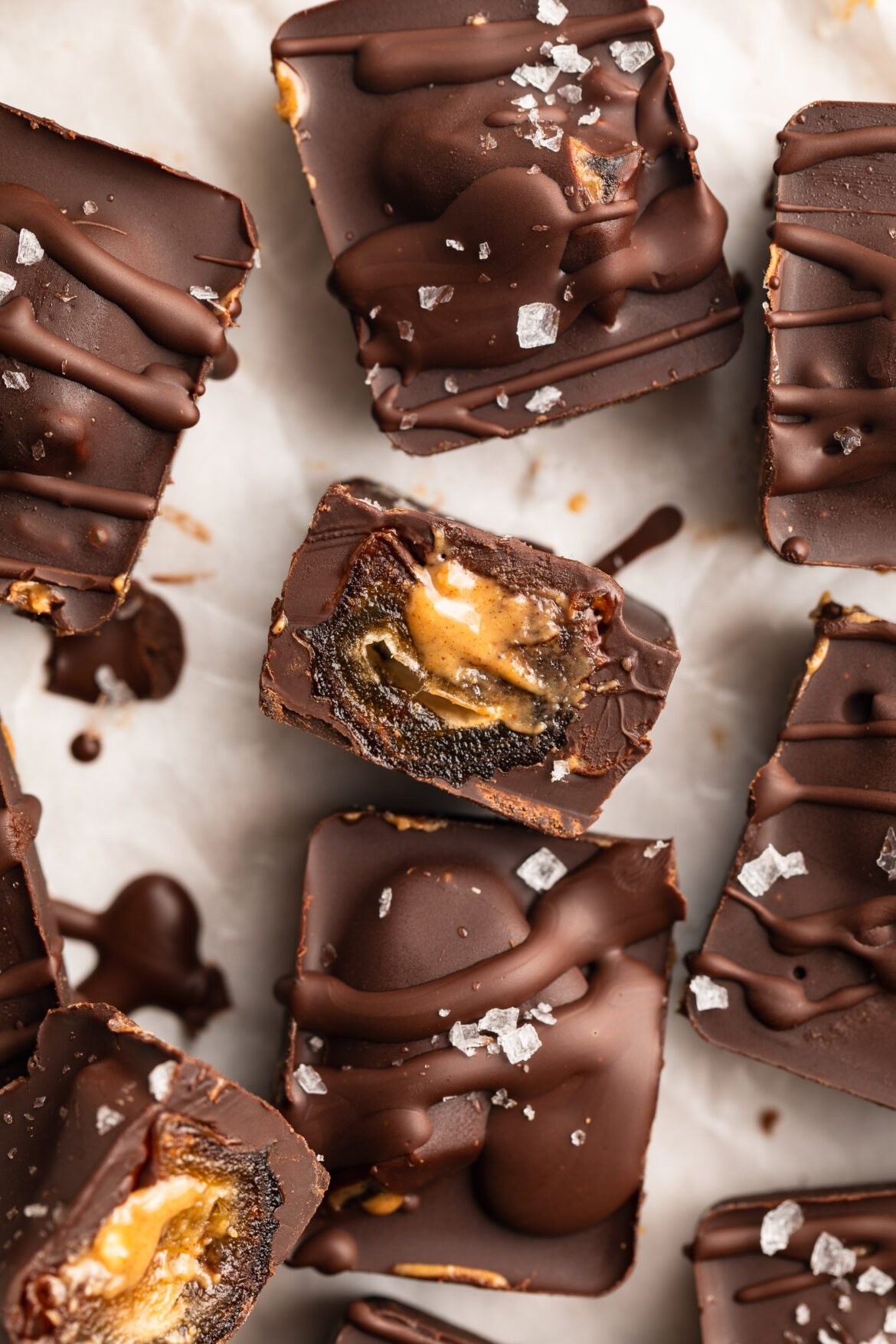 4-Ingredient Healthy Snickers overhead image of healthy snickers cut in half with peanut butter inside.