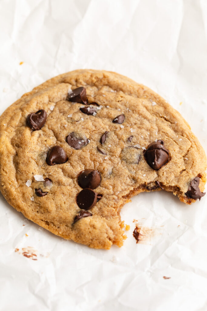 single serve protein cookie with a bite taken out.
