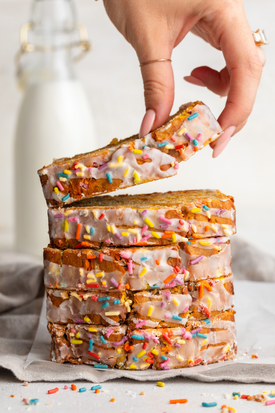 5 Ingredient Birthday Cake Banana Bread (gluten-free!) 5 ingredient gluten-free birthday cake banana bread slices stacked on top of each other.