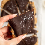 a piece of protein cookie dough bark with flaky salt on top.