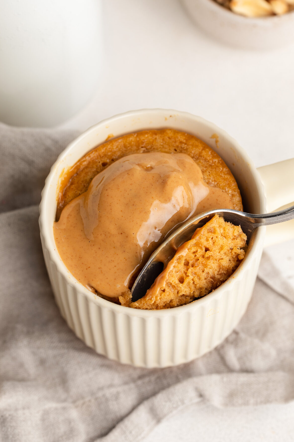 3-Ingredient Peanut Butter Mug Cake 3 ingredient peanut butter mug cake with extra peanut butter on top.