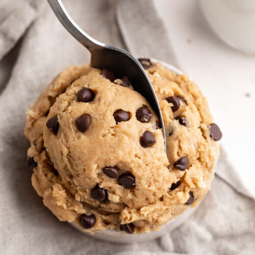 5 ingredient edible protein chocolate chip cookie dough in a small cup with a spoon.