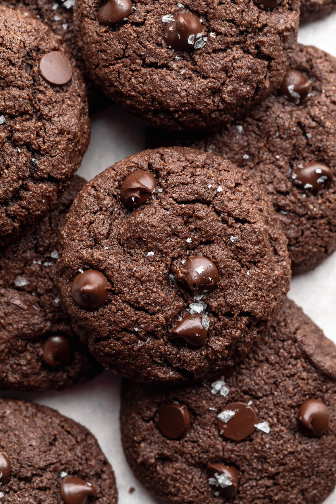 Almond Flour Chocolate Cookies almond flour chocolate cookies on top of each other of a baking sheet.