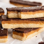 healthy twix bars stacked on top of each other with flaky salt on top.