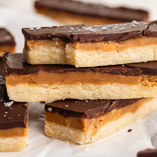 healthy twix bars stacked on top of each other with flaky salt on top.