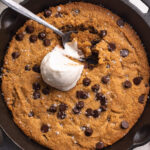overhead image of healthy gluten-free cookie skillet with a scoop of vanilla ice cream on top.