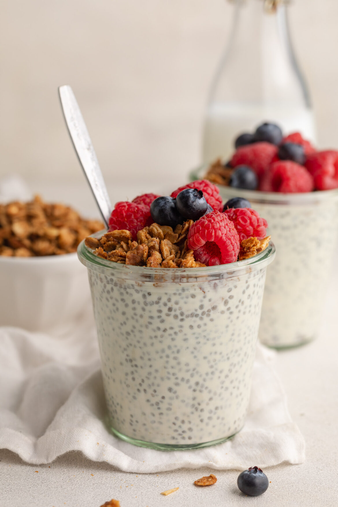 Chia Seed Protein Pudding (30g protein!) chia seed protein pudding in a glass jar with fresh blueberries and homemade granola on top.