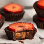 a healthy strawberry peanut butter cup with a bite taken out.