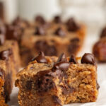 a slice of chocolate chip date cake with a bite taken out.