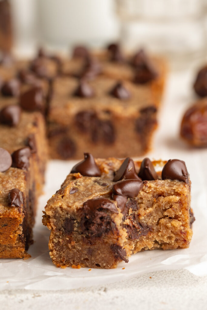 chocolate chip date cake with a bite taken out.