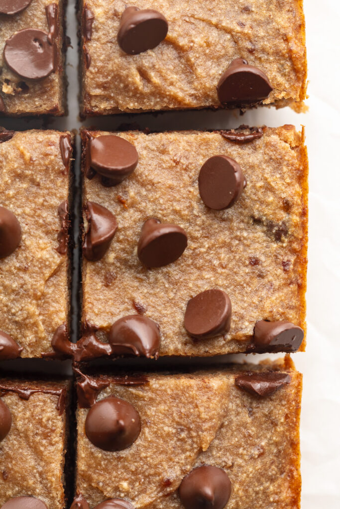 overhead image of chocolate chip date cake cut into squares