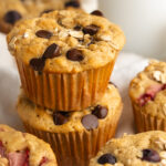 two healthy breakfast muffins with chocolate chips stacked on top of each other.