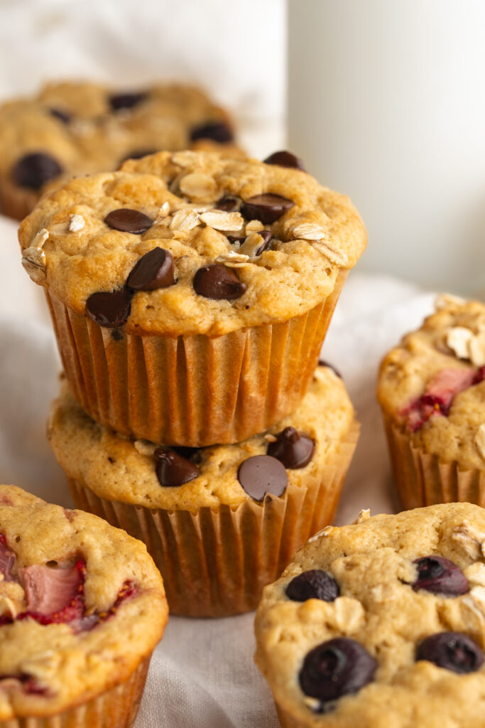 two healthy breakfast muffins with chocolate chips stacked on top of each other.