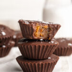 3 healthy date caramel cups stacked on top of each other.