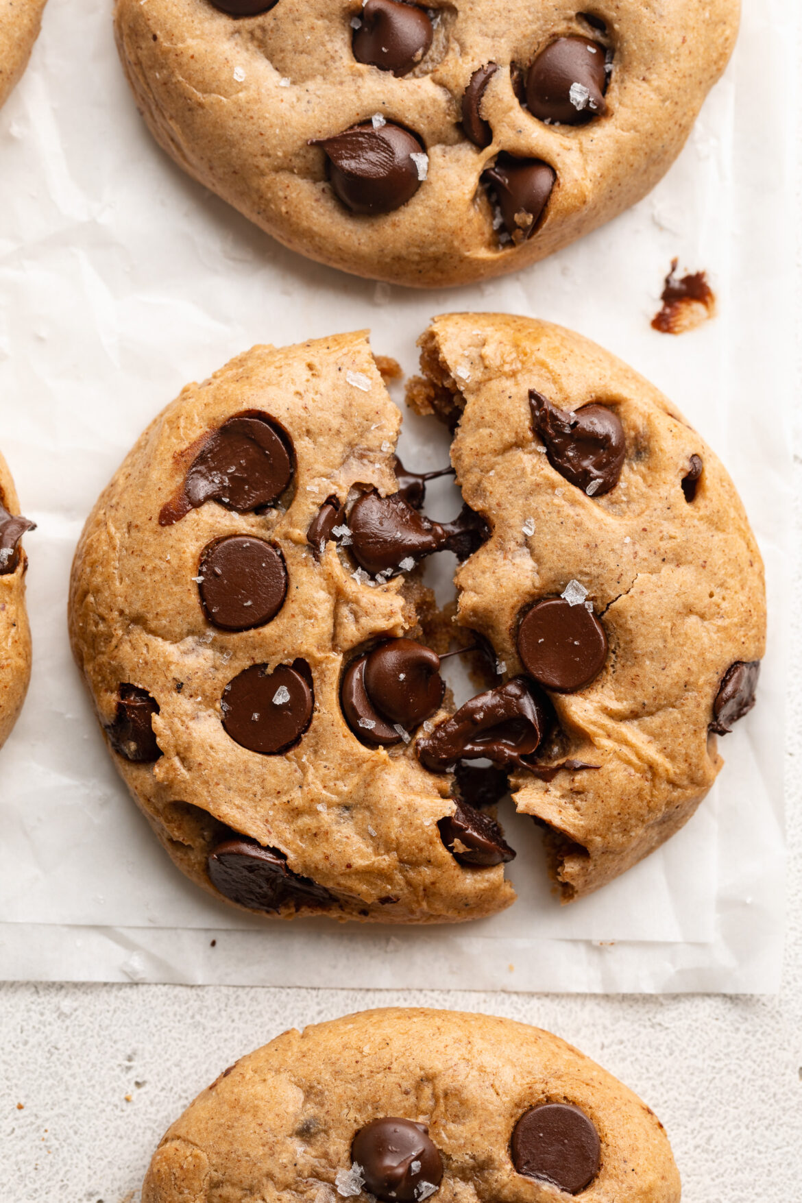 The BEST Protein Cookies (one-bowl!) overhead image of a protein cookie cut in half.