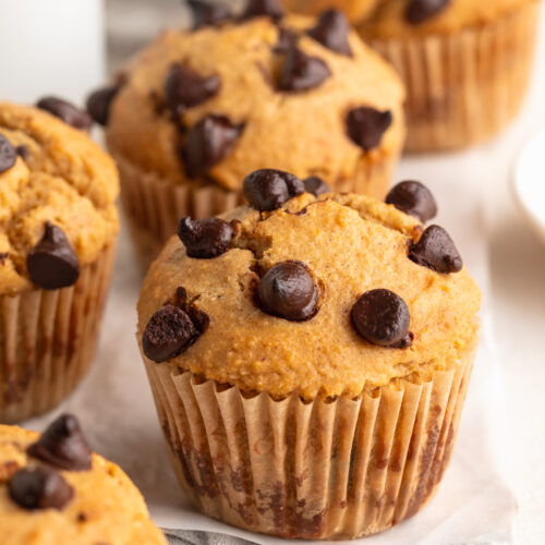 protein muffins on a table with chocolate chips on top.