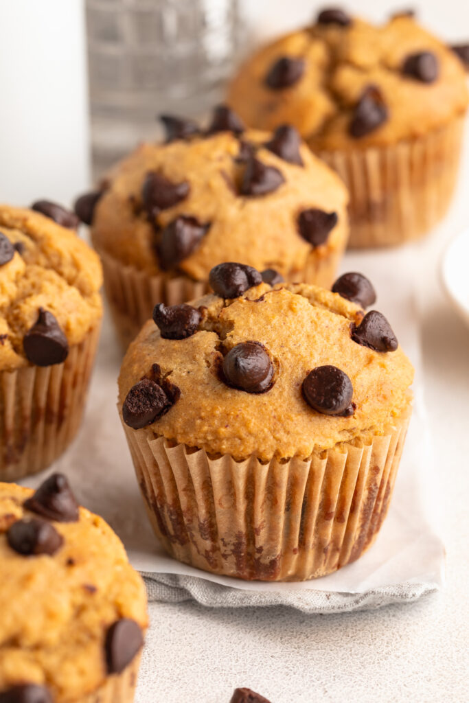 protein muffins on a table with chocolate chips on top.