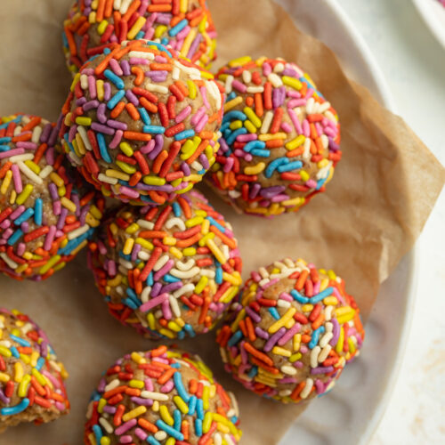 overhead image of birthday cake energy bites on a plate.