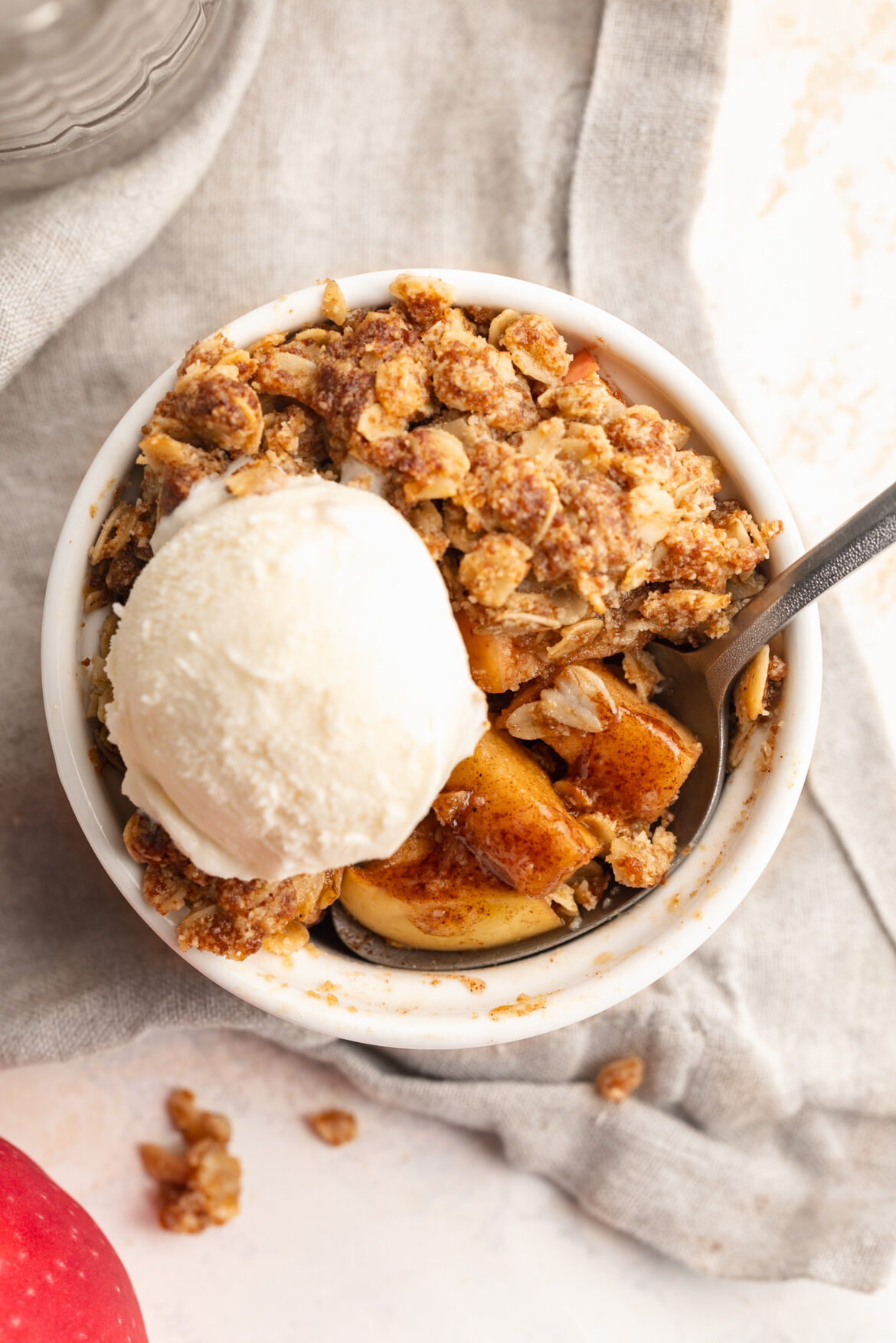 5-Ingredient Single Serve Apple Crumble overhead image of single serve apple crumble with a scoop of ice cream on top.