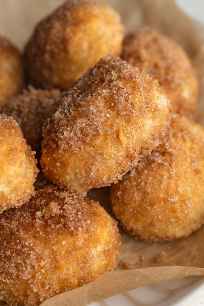 close up image of cinnamon sugar pretzel bites on a plate.