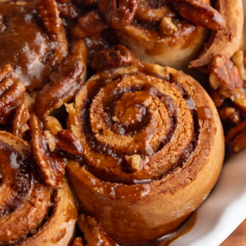 gluten free dairy free pecan cinnamon rolls in a baking dish.