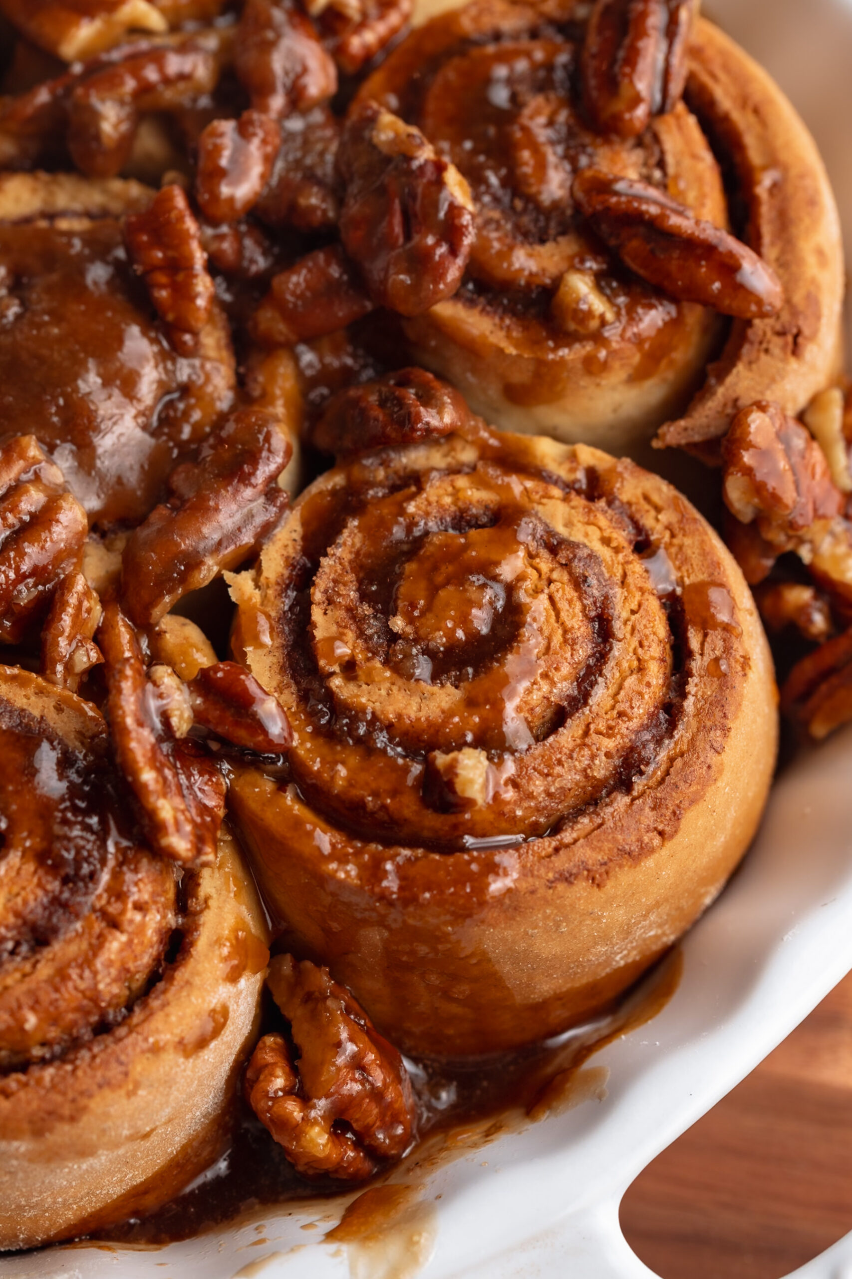 gluten free dairy free pecan cinnamon rolls in a baking dish.