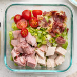 overhead image of a meal prep turkey club chopped salad.