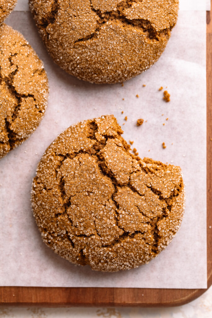 one gluten-free molasses cookie with a bite taken out.