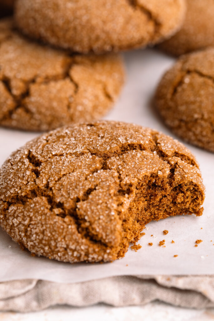 a gluten-free molasses cookie with a bite taken out.
