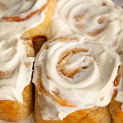 protein cinnamon rolls with greek yogurt cream cheese frosting on top.