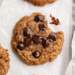 overhead image of 3 ingredient protein cookies with a bite taken out.