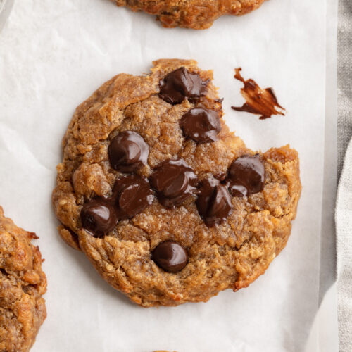 overhead image of 3 ingredient protein cookies with a bite taken out.
