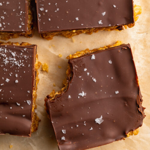 overhead image of peanut butter cornflake bars with a bite taken out.