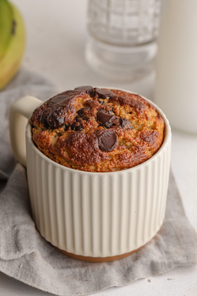 healthy banana mug cake with chocolate chips on top.