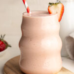 cottage cheese smoothie with a strawberry on the side.