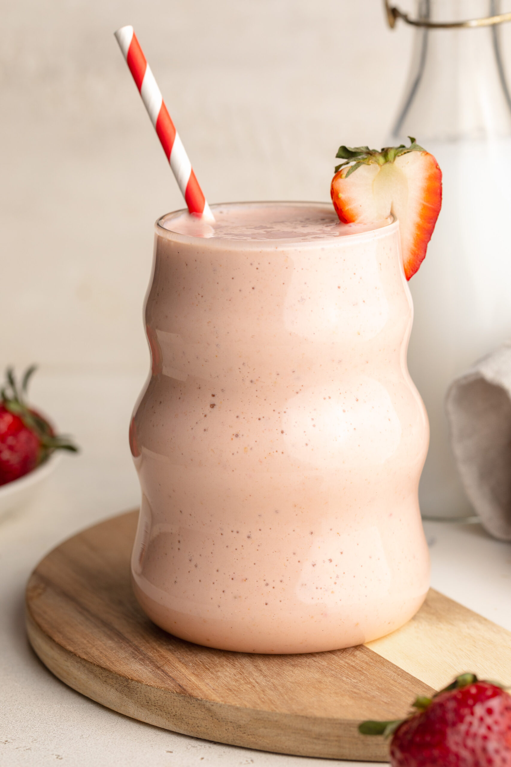 cottage cheese smoothie with a strawberry on the side.