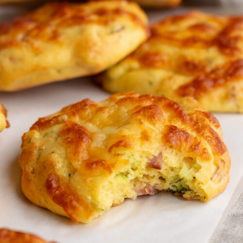 high protein breakfast biscuits on a table with a bite taken out.