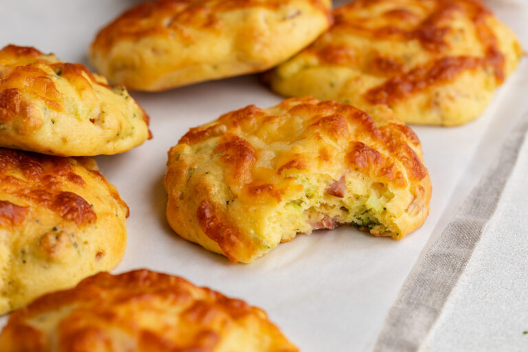 high protein breakfast biscuits on a table with a bite taken out.