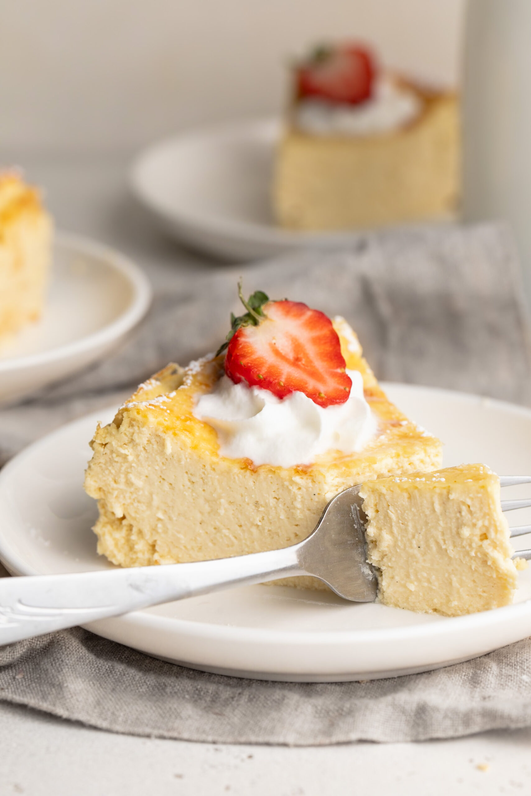 5 ingredient healthy cheesecake slice on a plate with a fork.