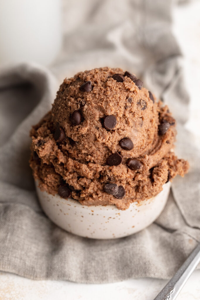 cottage cheese brownie batter scooped into a small cup.