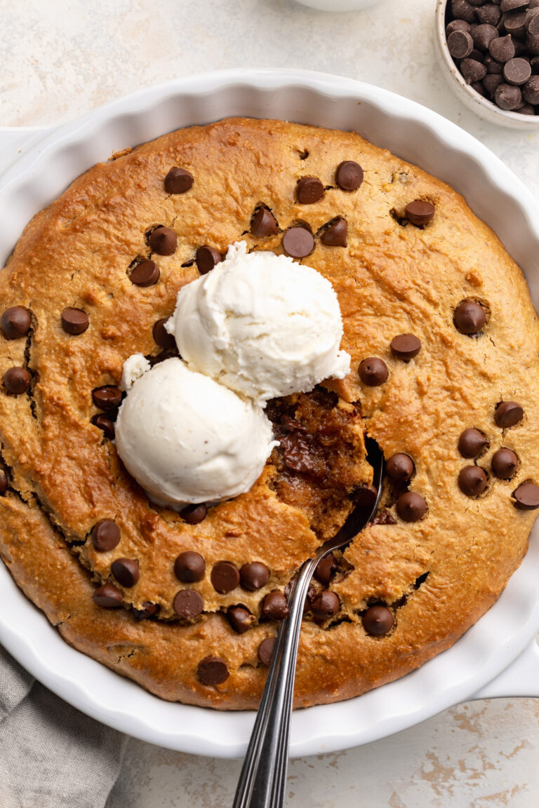 overhead image of healthy cookie pie in a pie dish with ice cream on top.