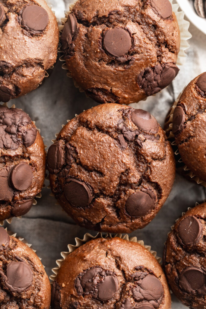overhead image of double chocolate protein muffins lined up on a table.