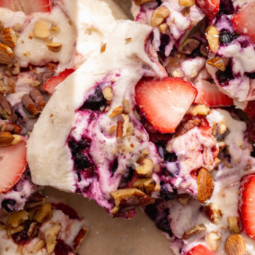 close up image a piece of frozen yogurt bark with fresh strawberries on top.