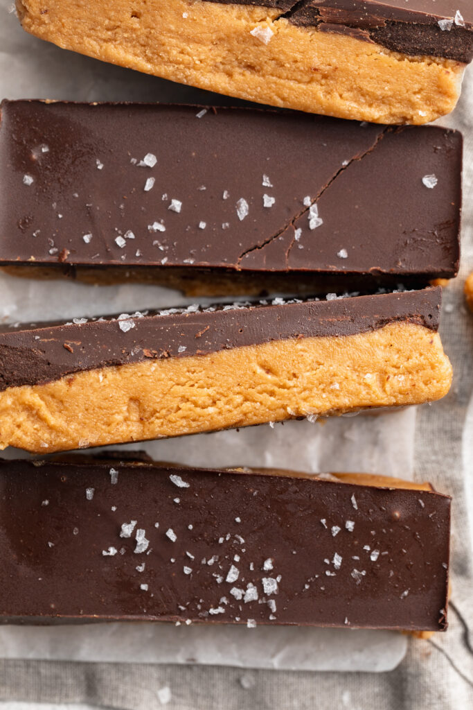 healthy peanut butter cup bars sliced with flaky salt on top.