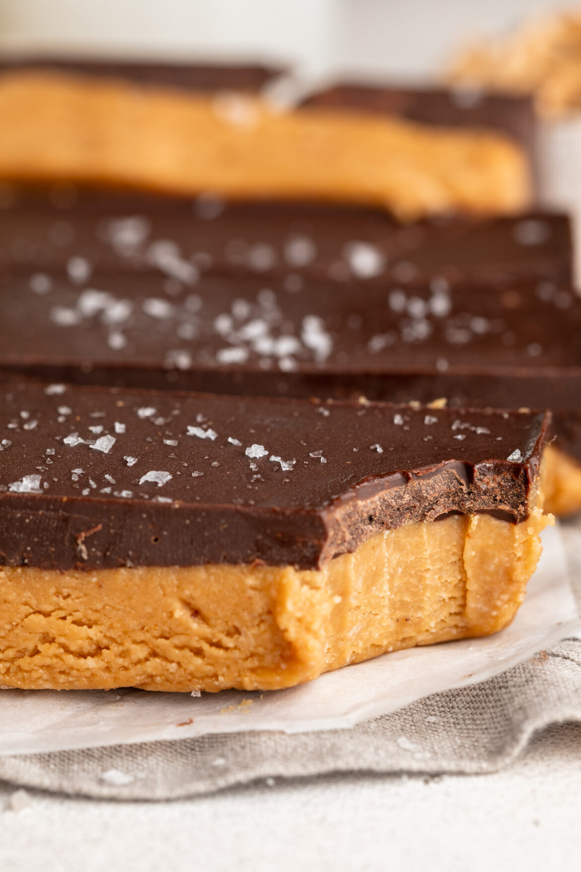 close up image of a bite taken out of a healthy peanut butter cup bars.