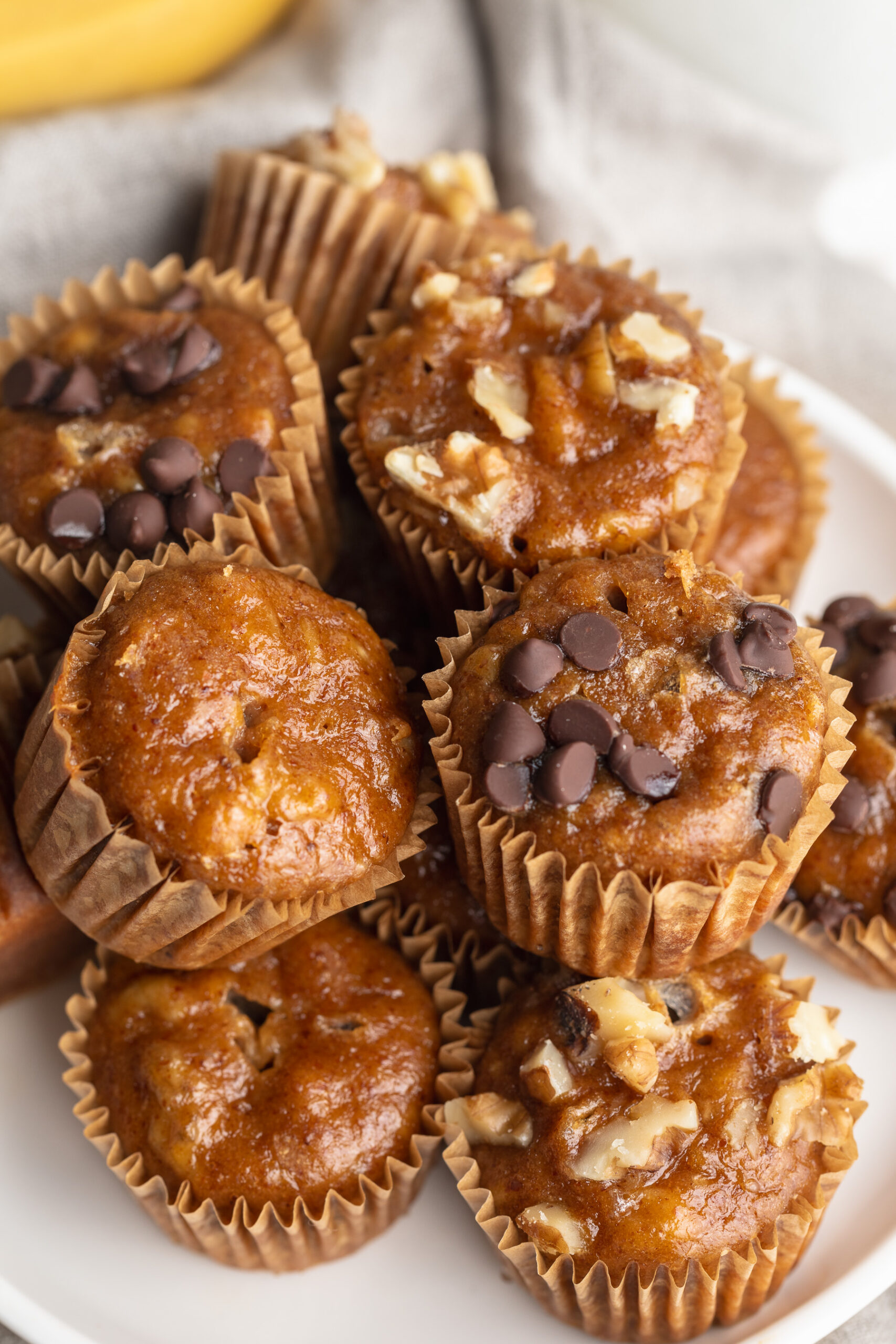 mini banana muffins piled on a plate.