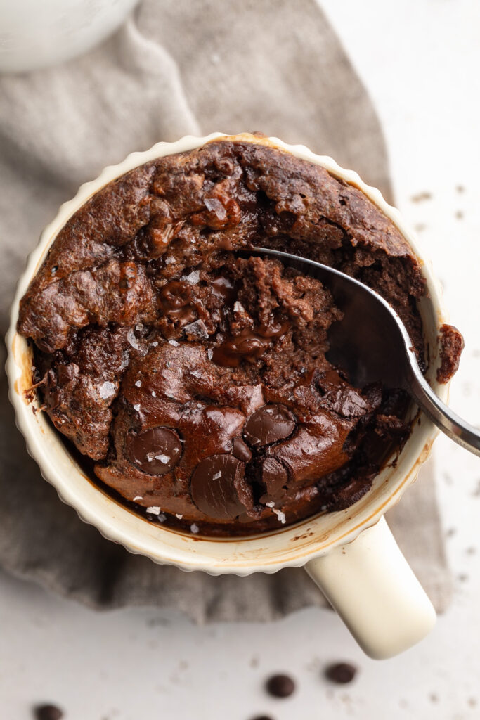 overhead image of a protein brownie mug cake with a spoon in it.