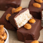 healthy almond joys bars, one cut in half to show the inside.