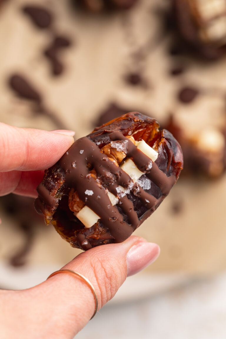 Butter Pecan Stuffed Dates hand holding a butter pecan stuffed date.