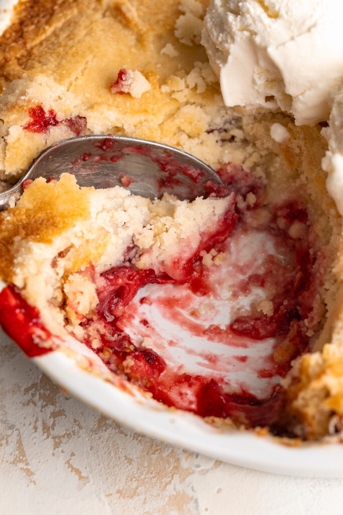 close up image of 3 ingredient strawberry dump cake being scooped.